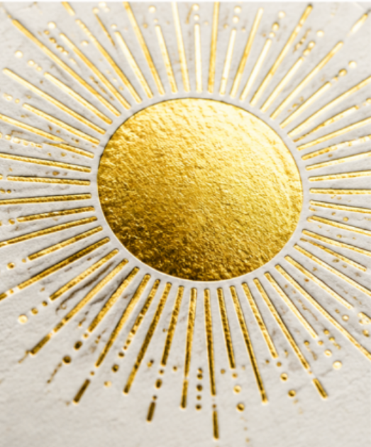 Metallic gold foil sun and fine border on navy packaging board
